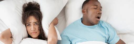 Snoring man sleeping with apnea and sleepless woman, angry wife unable to get to sleep